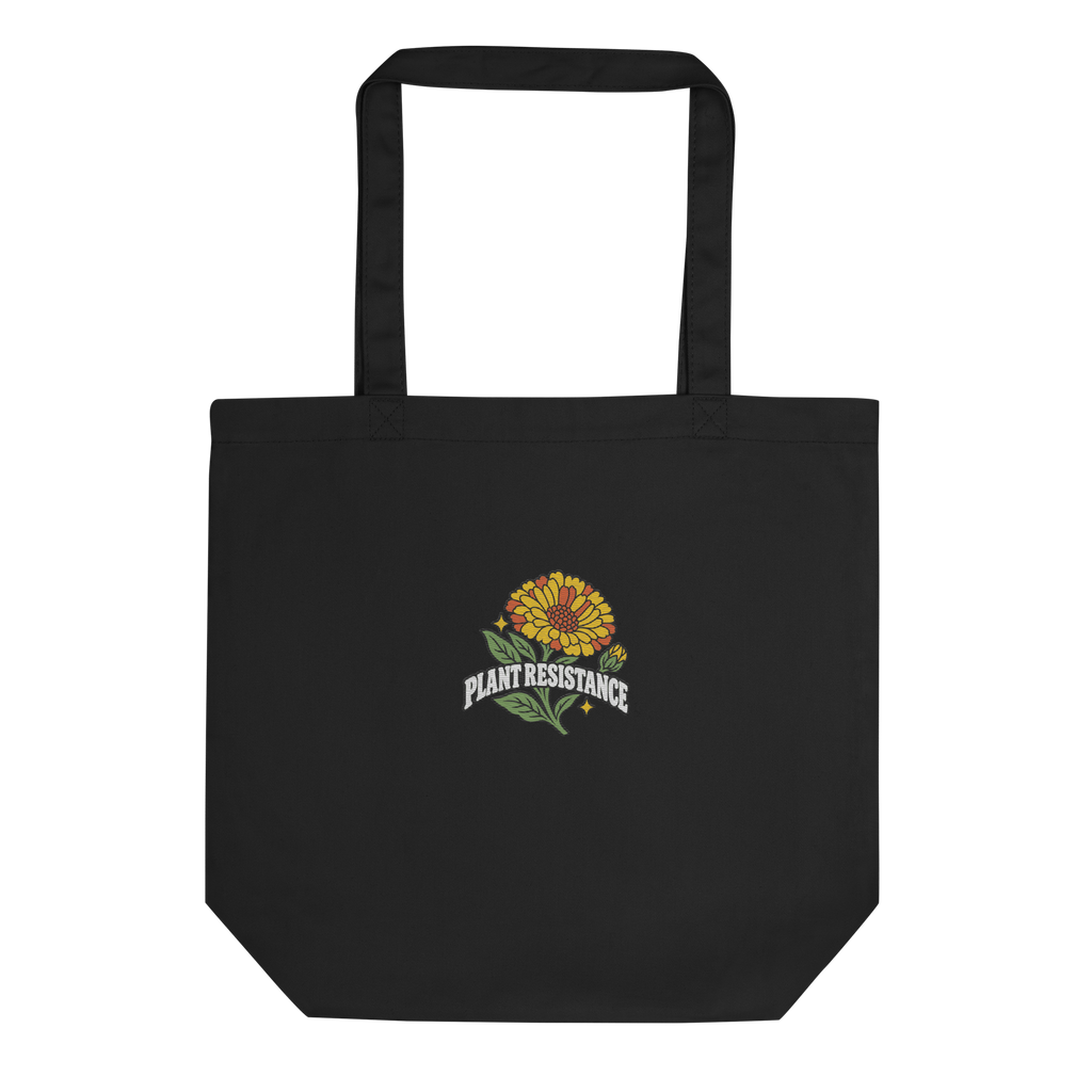 Black organic cotton tote bag with embroidered Plant Resistance calendula design. Schwarze Bio-Baumwolltasche mit gesticktem Plant Resistance Ringelblumen-Design.