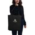 Black organic cotton tote bag with embroidered Plant Resistance daisy design. Schwarze Bio-Baumwolltasche mit gesticktem Plant Resistance Gänseblümchen-Design.