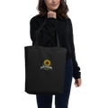 Black organic cotton tote bag with embroidered Plant Resistance sunflower design. Schwarze Bio-Baumwolltasche mit gesticktem Plant Resistance Sonnenblumen-Design.