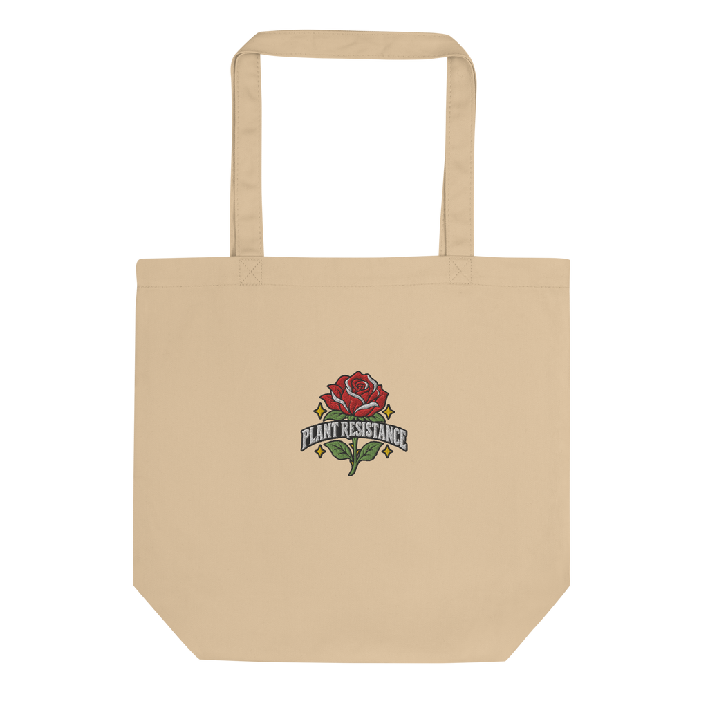Black organic cotton tote bag with embroidered Plant Resistance rose design. Schwarze Bio-Baumwolltasche mit gesticktem Plant Resistance Rosen-Design.